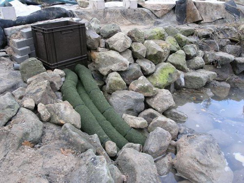 Schacht-Einbau bei einer Sanierung. Die Leitungen sind mit der Schlauchtarnung verkleidet und werden wie der Schacht noch mit Steinen abgedeckt. Schacht-Einbau bei einer Sanierung. Die Leitungen sind mit der Schlauchtarnung verkleidet und werden wie der Schacht noch mit Steinen abgedeckt.